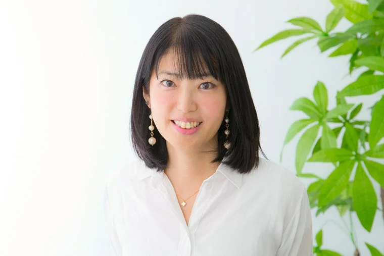白いシャツを着た笑顔の日本人女性のポートレート