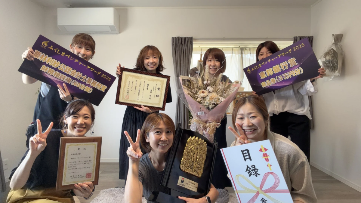 複数の賞状やトロフィー、花束を手に笑顔の女性たち